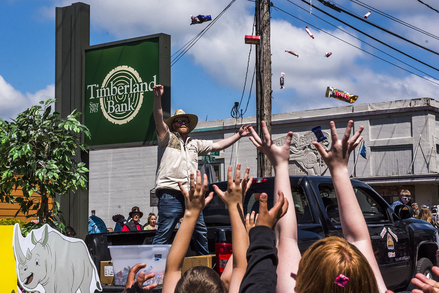Kids reach to the sky as candy falls after being thrown from the Winlock Assembly float during the Egg Day parade in 2018.